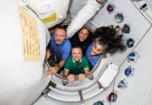 a group of people standing inside of a space station