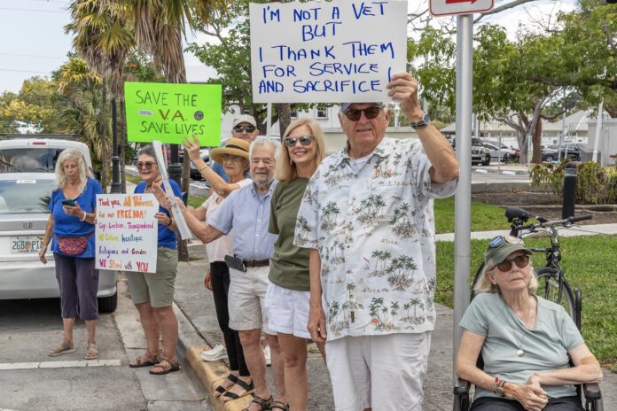 Protest Vets & Feds 14 March 2024 NWM--12 Large a group of people standing on a sidewalk holding signs