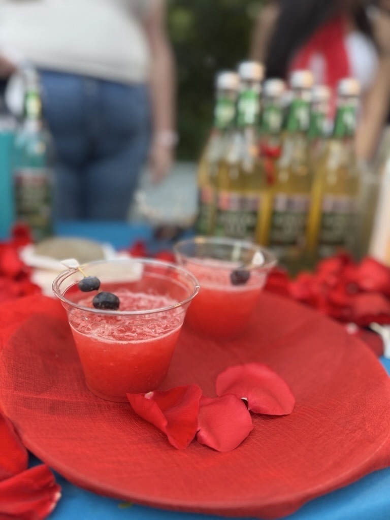 a red plate topped with two glasses filled with liquid