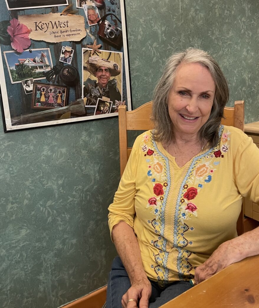 a woman sitting at a table in a room