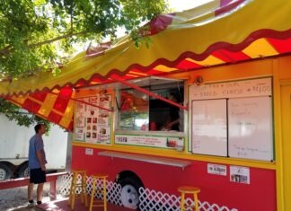 a man standing in front of a food truck