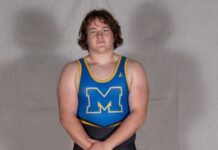 a man in a blue and yellow wrestling singlet