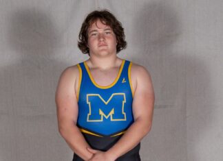 a man in a blue and yellow wrestling singlet
