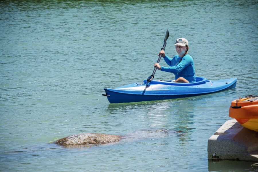a woman is paddling a kayak in the water