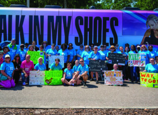 a group of people standing in front of a bus