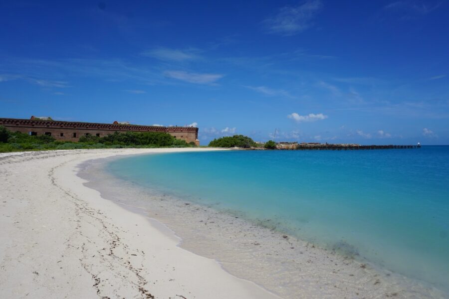 a white sandy beach with clear blue water