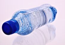 a plastic water bottle sitting on a white surface