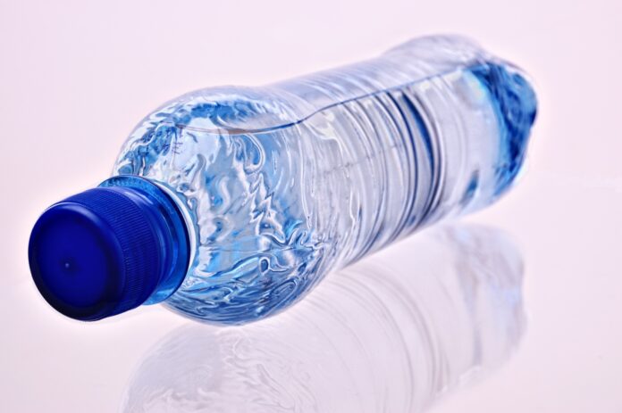 a plastic water bottle sitting on a white surface