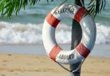 white and orange welcome aboard buoy