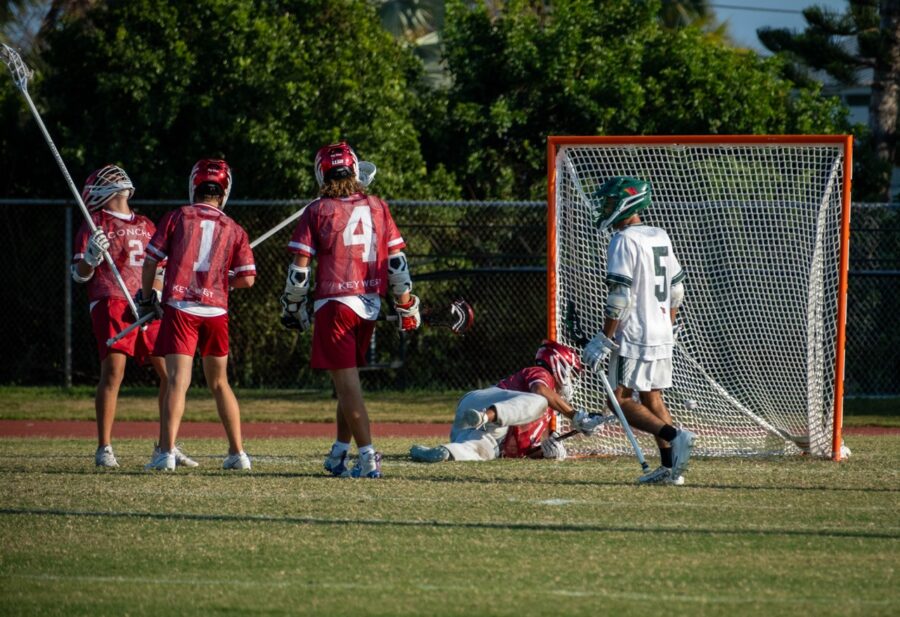 a group of young men playing a game of lacrosse