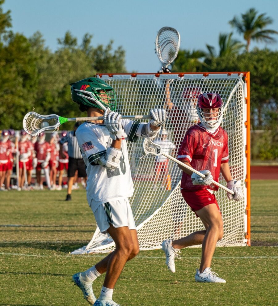 a group of young men playing a game of lacrosse