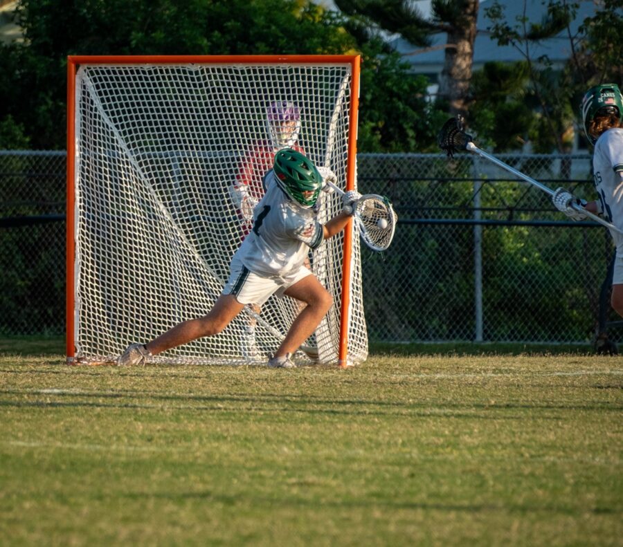 a group of young men playing a game of lacrosse