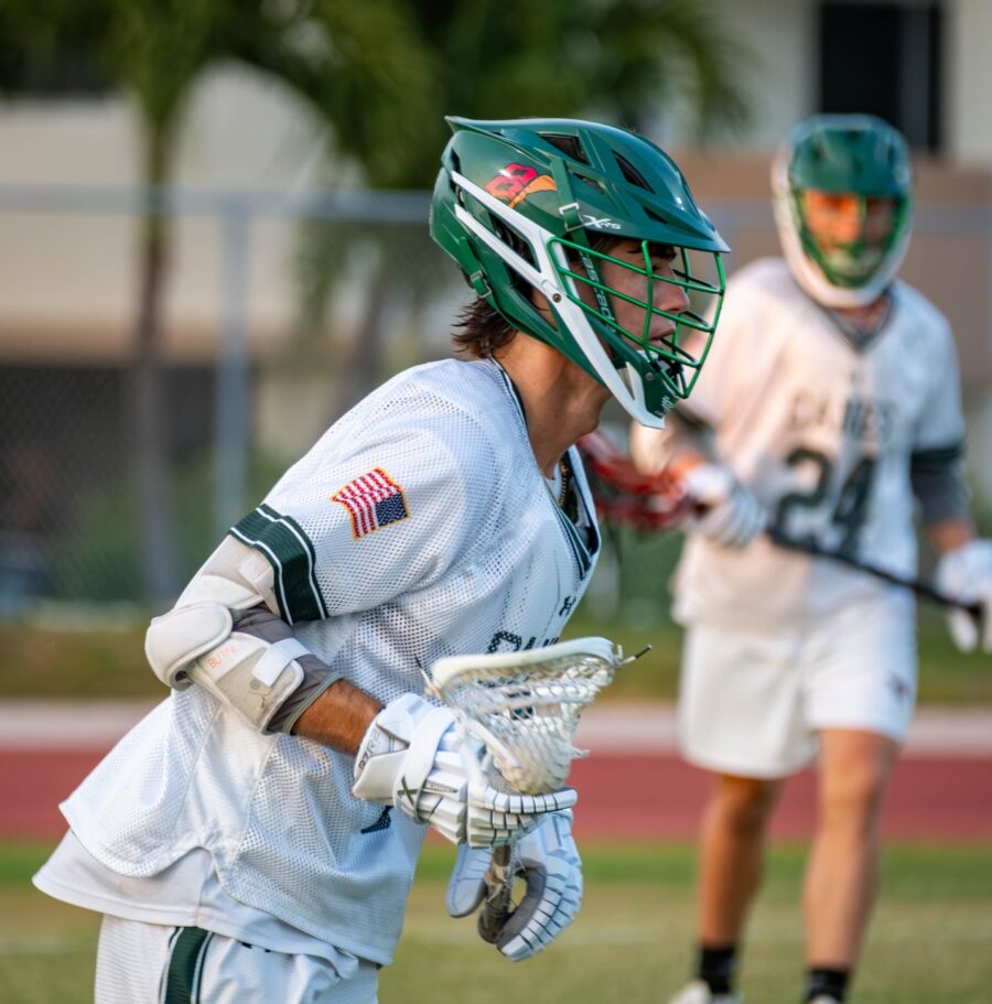 a couple of men playing a game of lacrosse