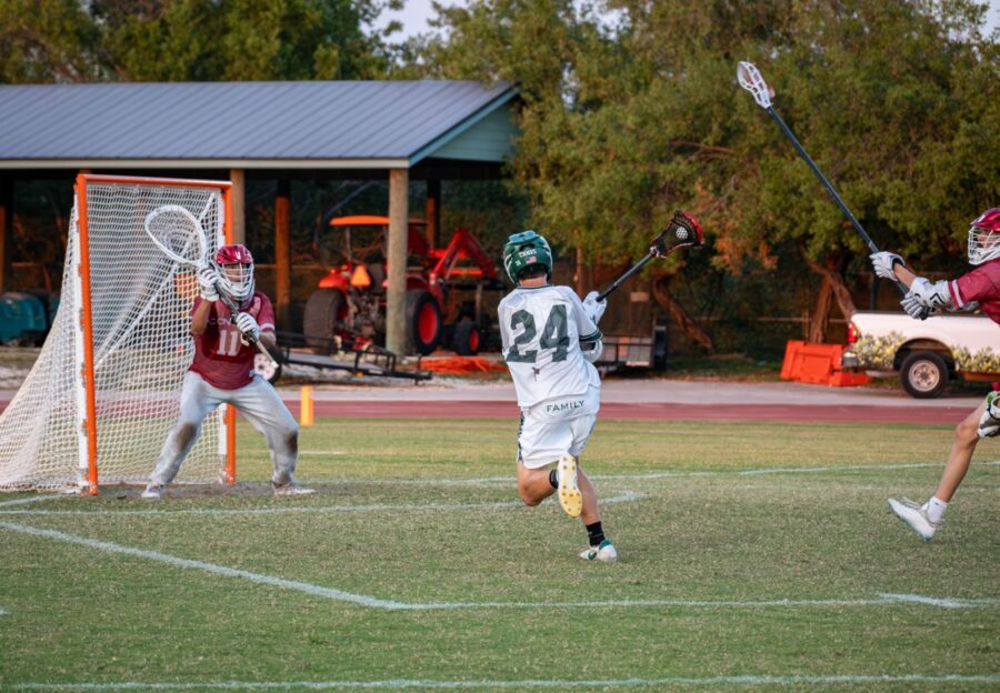 a group of young men playing a game of lacrosse