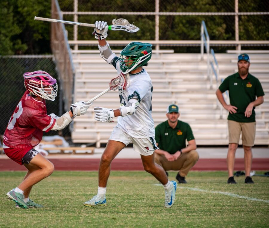 a group of young men playing a game of lacrosse