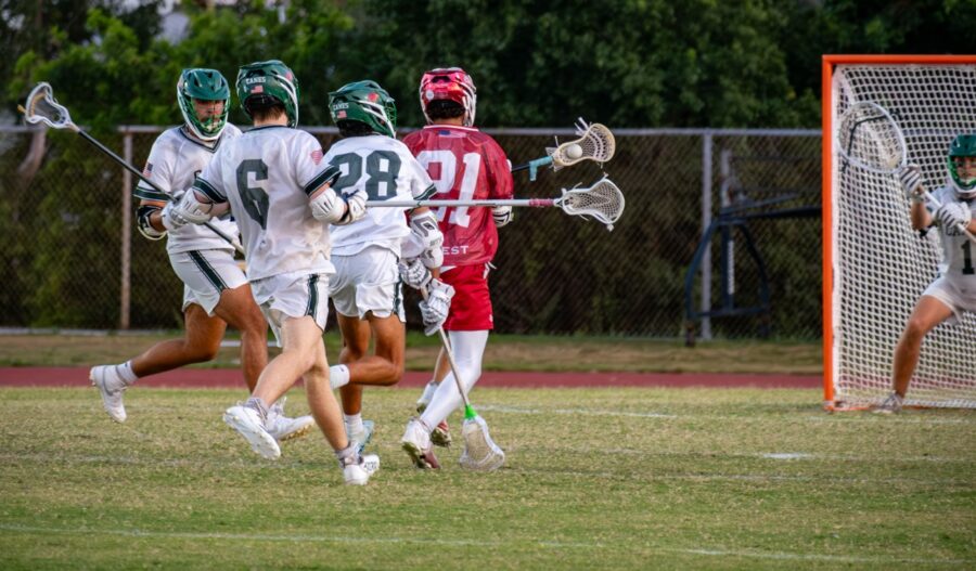 a group of young men playing a game of lacrosse