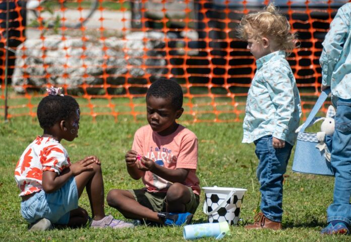 033024 Weekly Spring Fest egg hunt HR dfp-24 Large a group of children sitting on the grass