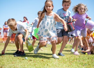 a group of young children playing a game of frisbee