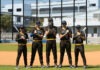 a group of baseball players standing on top of a field