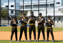 a group of baseball players standing on top of a field