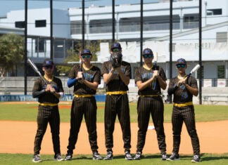 FINS & CONCHS BASEBALL SQUADS BATTLE IN THE SWEET 16 a group of baseball players standing on top of a field