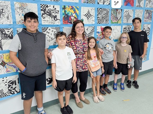 a group of people standing in front of a wall