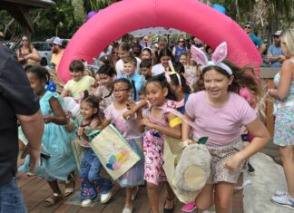 a group of children in bunny ears are dancing