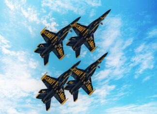 a group of fighter jets flying through a blue sky