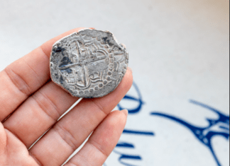 a person holding a coin in their hand