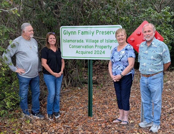 Council Members at Glynn Family Preserve a group of people standing in front of a sign