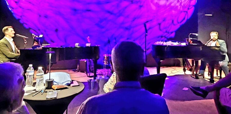 a group of people sitting in front of a piano