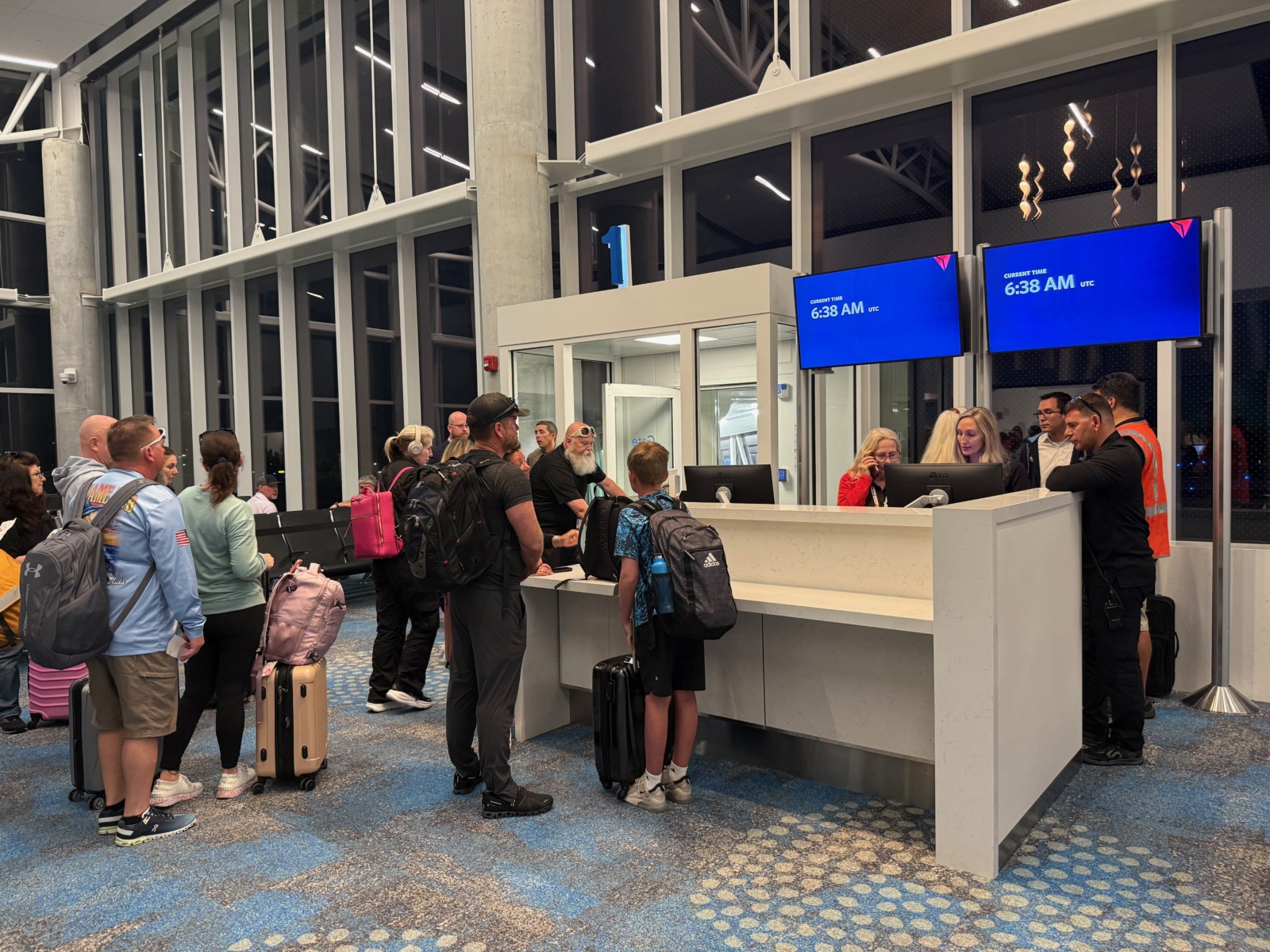 a group of people waiting in line at an airport