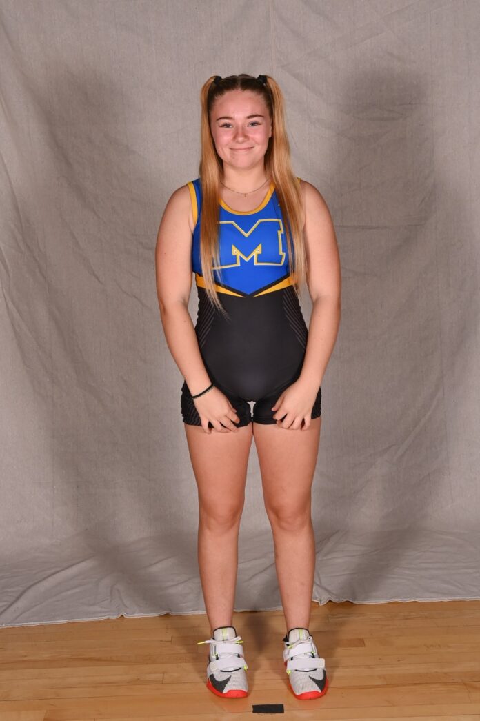 a woman in a wrestling suit posing for a picture