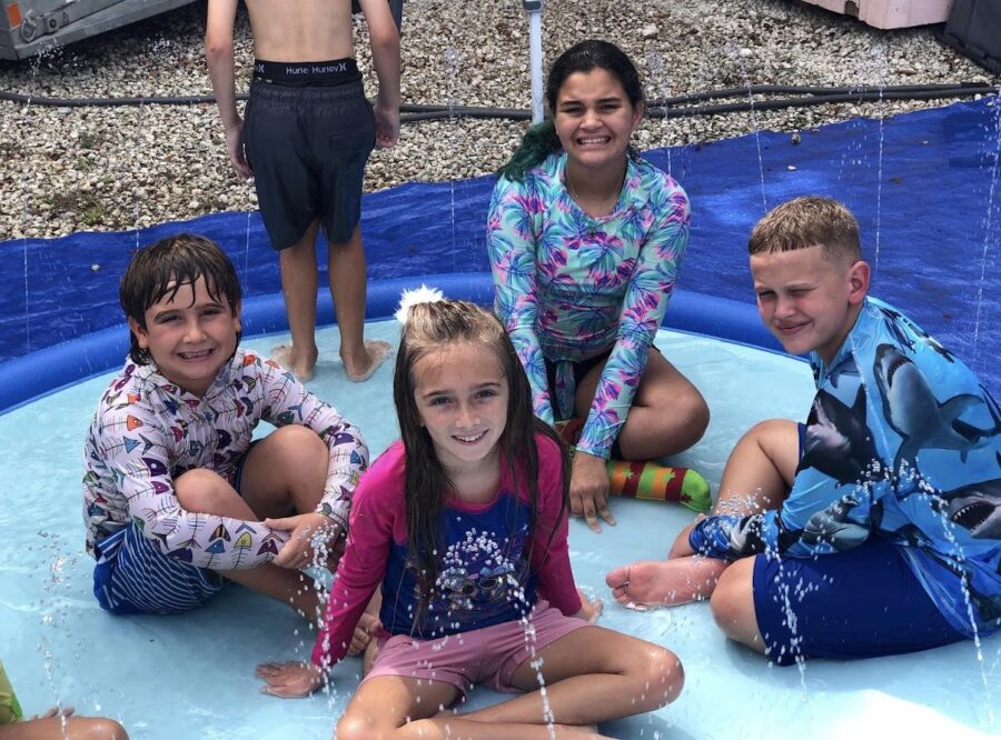 a group of children sitting on a water slide