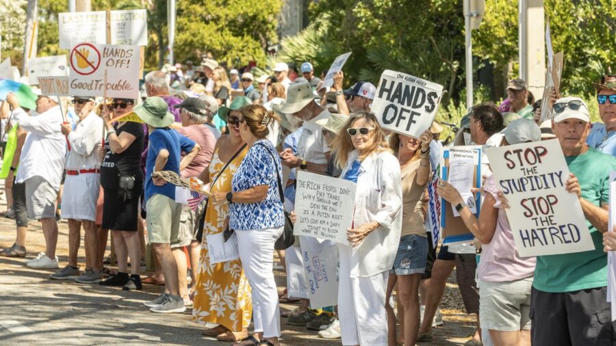 a group of people holding signs on a street