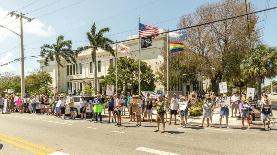 a group of people standing on the side of a road