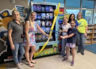 a group of people standing in front of a book store