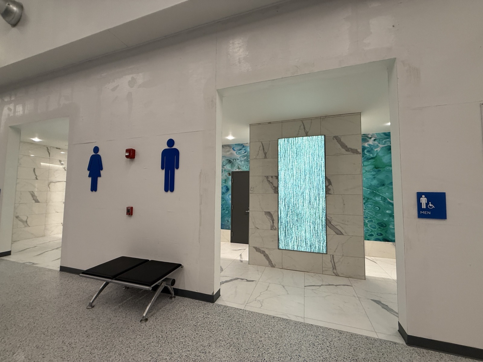 a bathroom with a bench in the middle of it