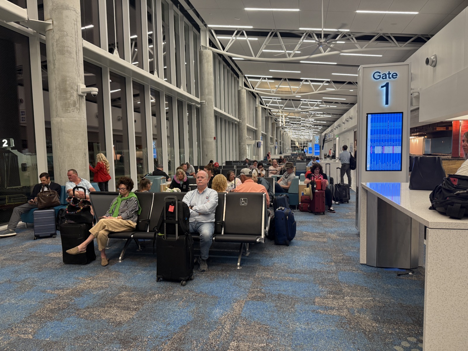 a group of people sitting in chairs in an airport