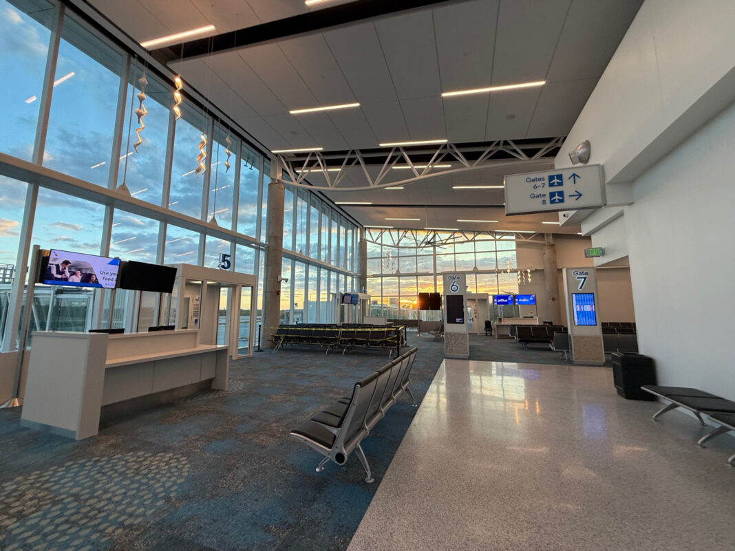 an empty airport terminal with lots of windows