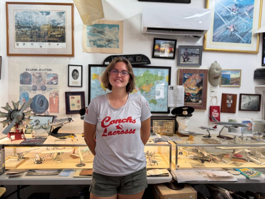 a woman standing in front of a display case