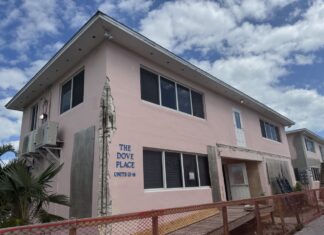 a pink building with a fence around it