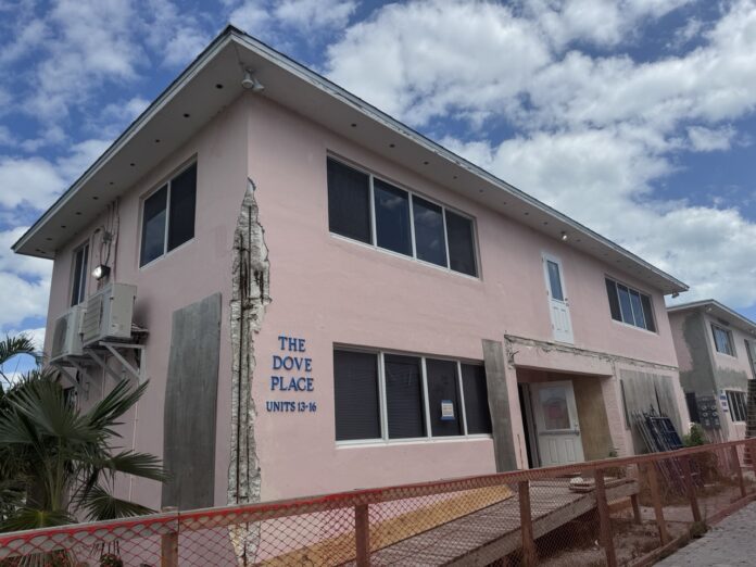 a pink building with a fence around it