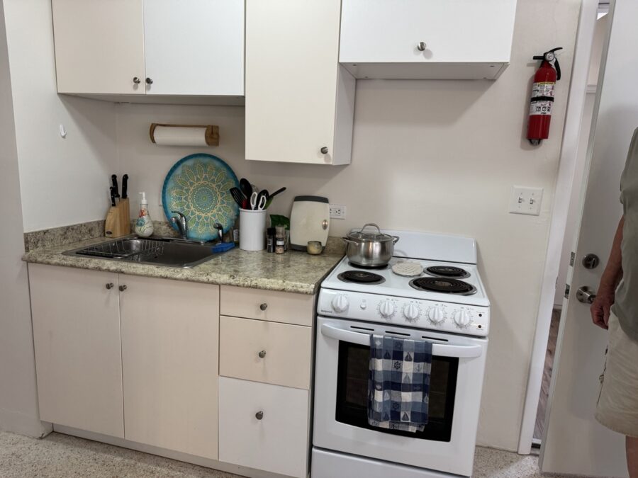 a white stove top oven sitting inside of a kitchen