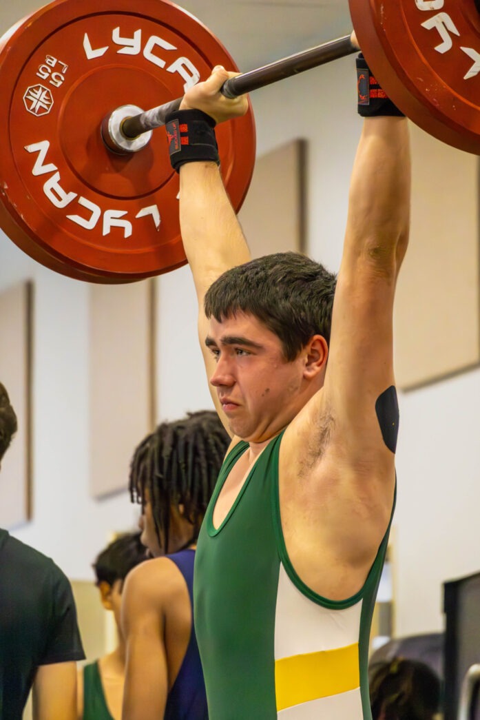 a man lifting a barbell in a gym