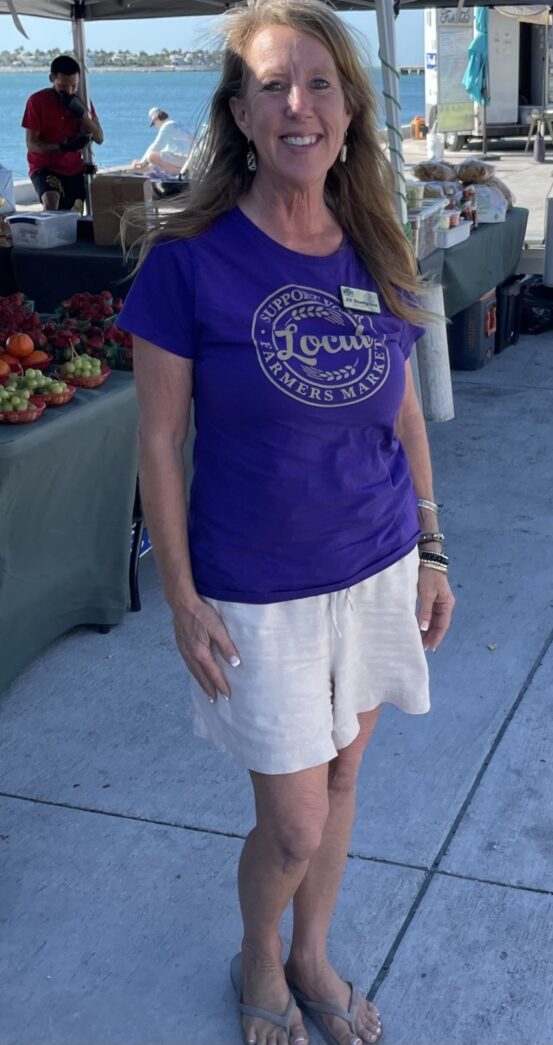 a woman in a purple shirt and white shorts