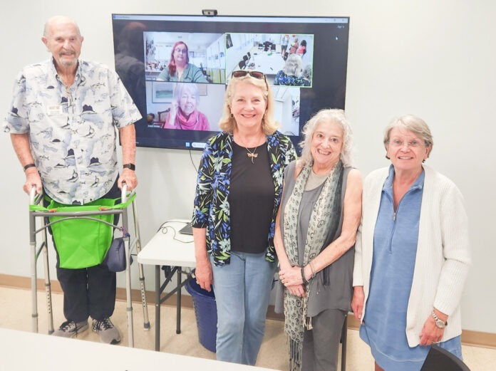 a group of people standing around a table