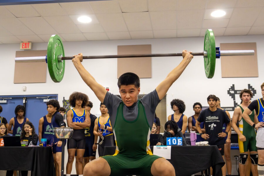 a man is doing a squat with a barbell