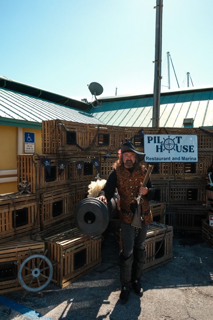 a man standing next to a pile of crates