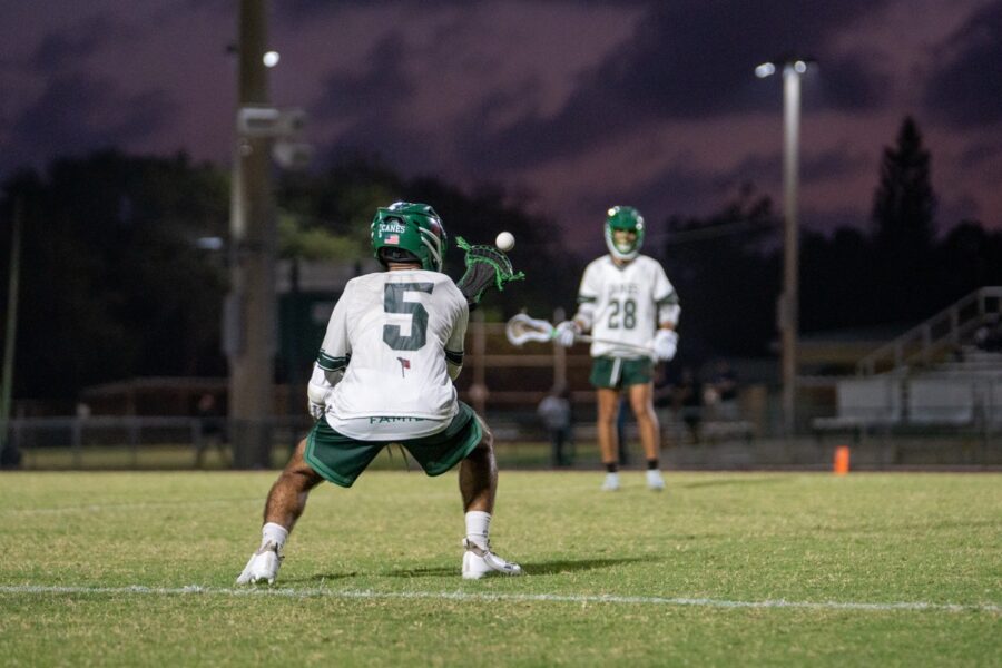 a group of young men playing a game of lacrosse